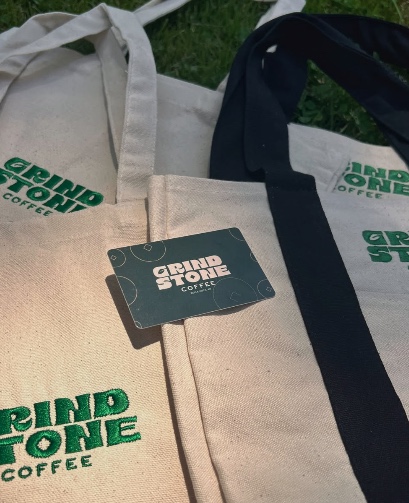 Grindstone Coffee gift card and tote bags